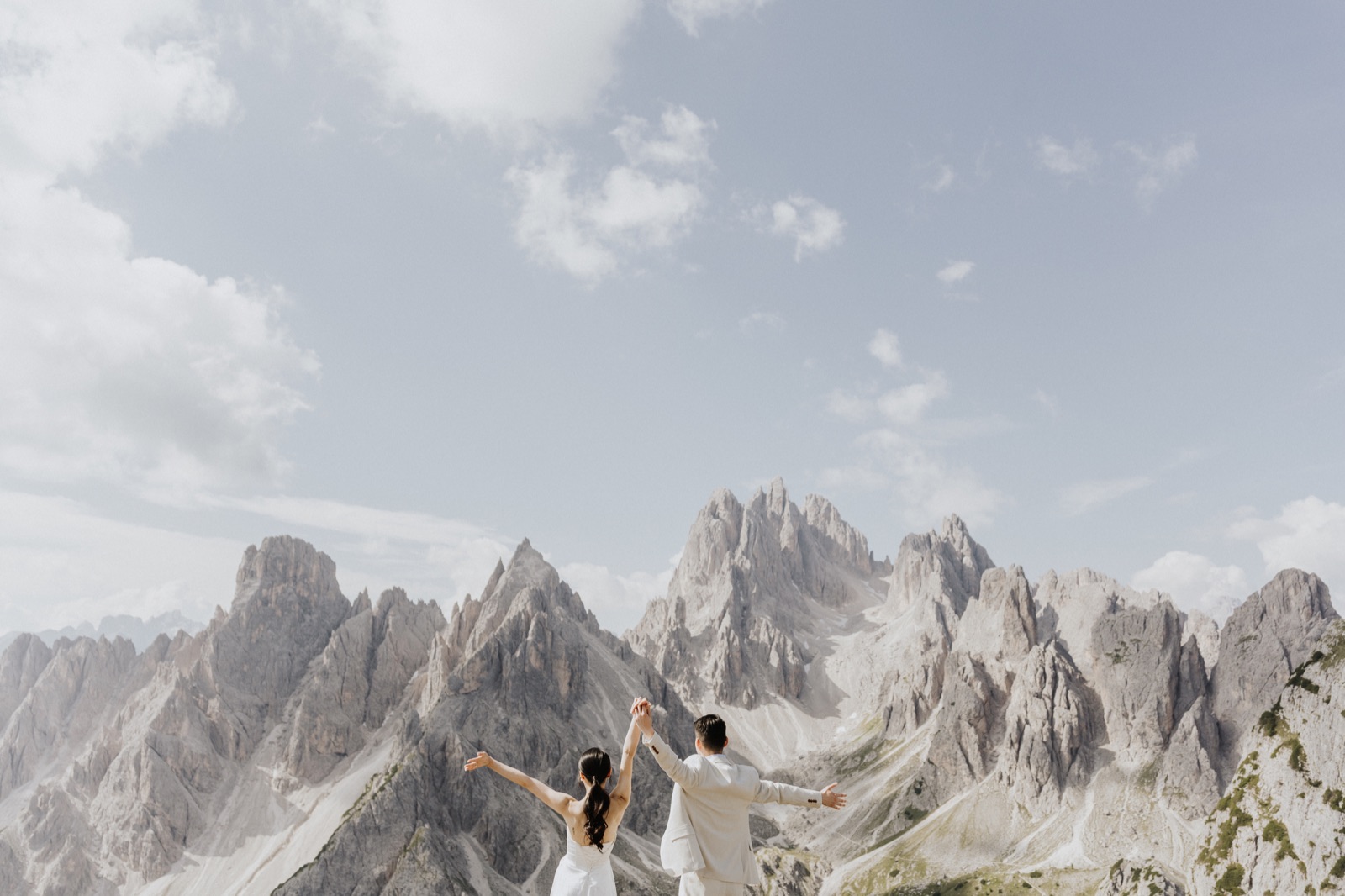 Cathleen and Justin celebrating together beneath the Dolomite mountains